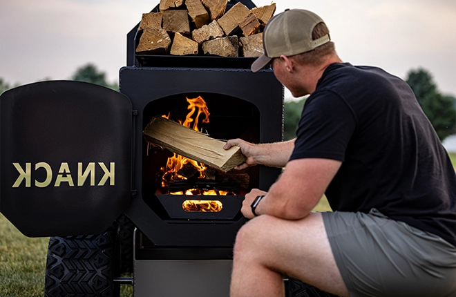 Loading wood into firebox in offset smoker